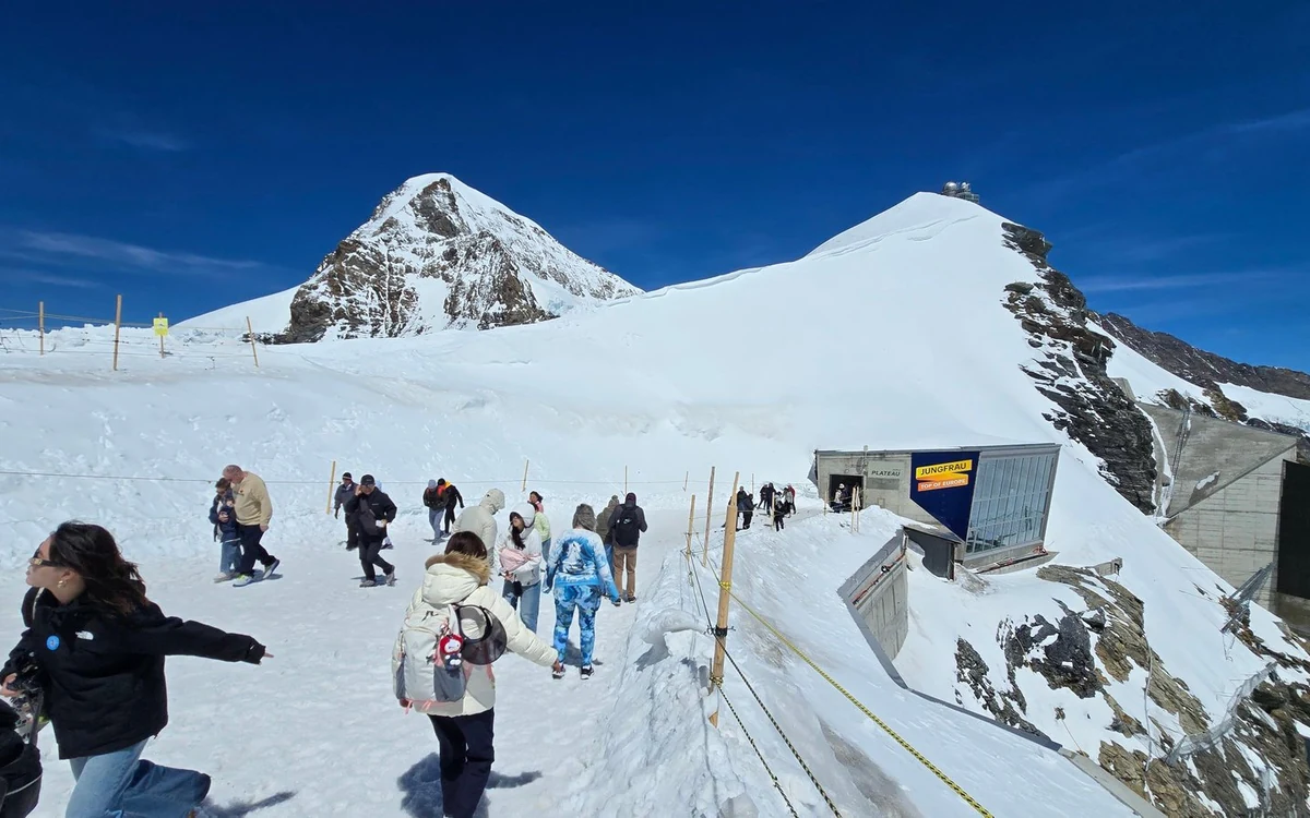 A tunnel in the Ice Palace inside the glacier at Jungfraujoch, with walls and floor made of ice, Switzerland