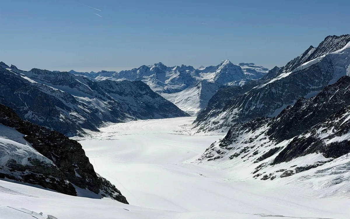 A Jungfrau Railway cogwheel train waiting at Kleine Scheidegg below the north face of the Eiger, Bernese Oberland, Switzerland